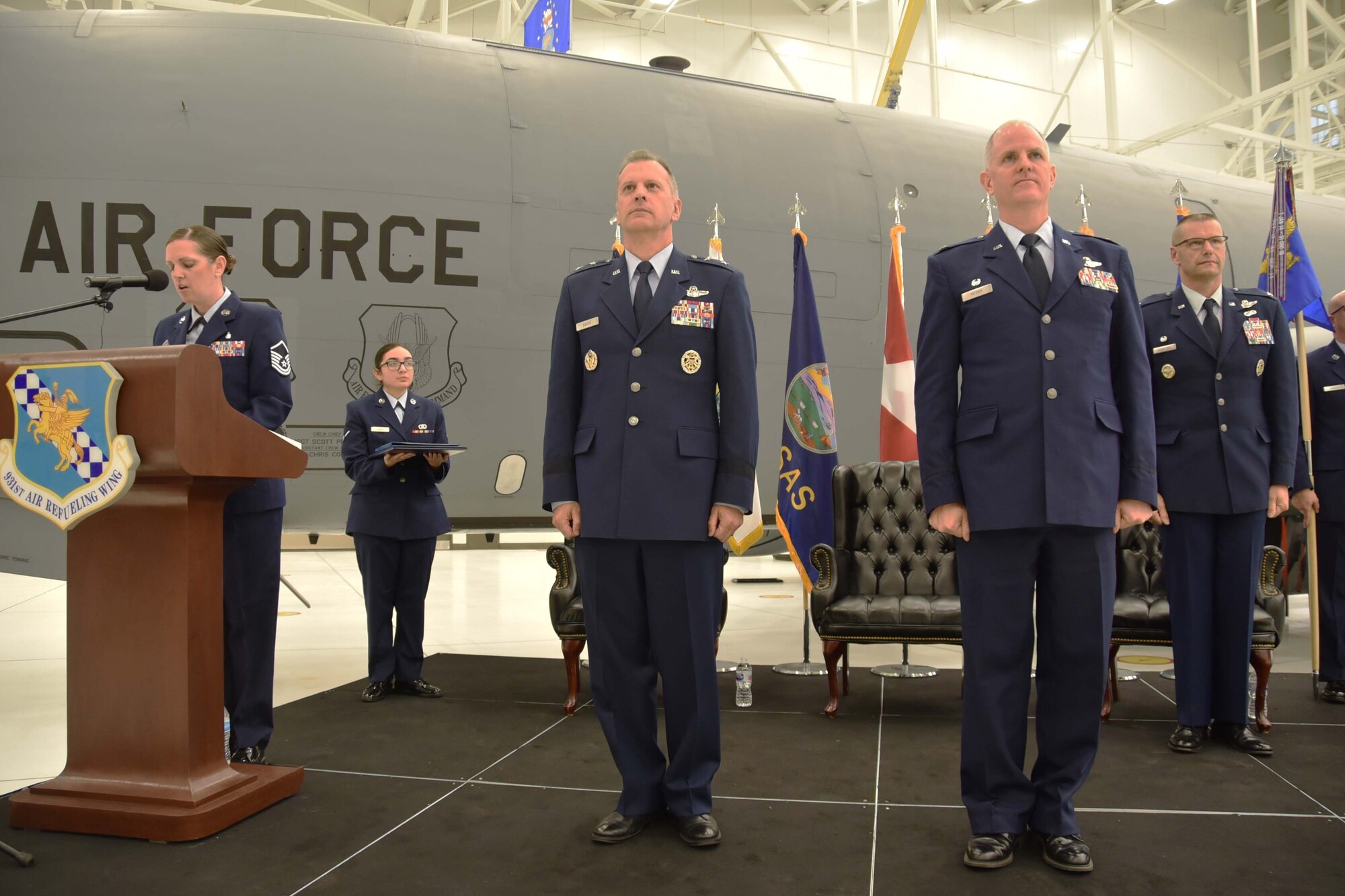 (Left to right) Master Sgt.Tabetha Coley, 931st Air Refueling Wing in-service recruiter, narrates the 931 ARW Change of Command ceremony Dec. 1, 2018, McConnell Air Force Base, Kan. Col. Phil Heseltine, 931 ARW commander, selected Coley to narrate the ceremony because of her year-long role in helping him join the Reserve.
