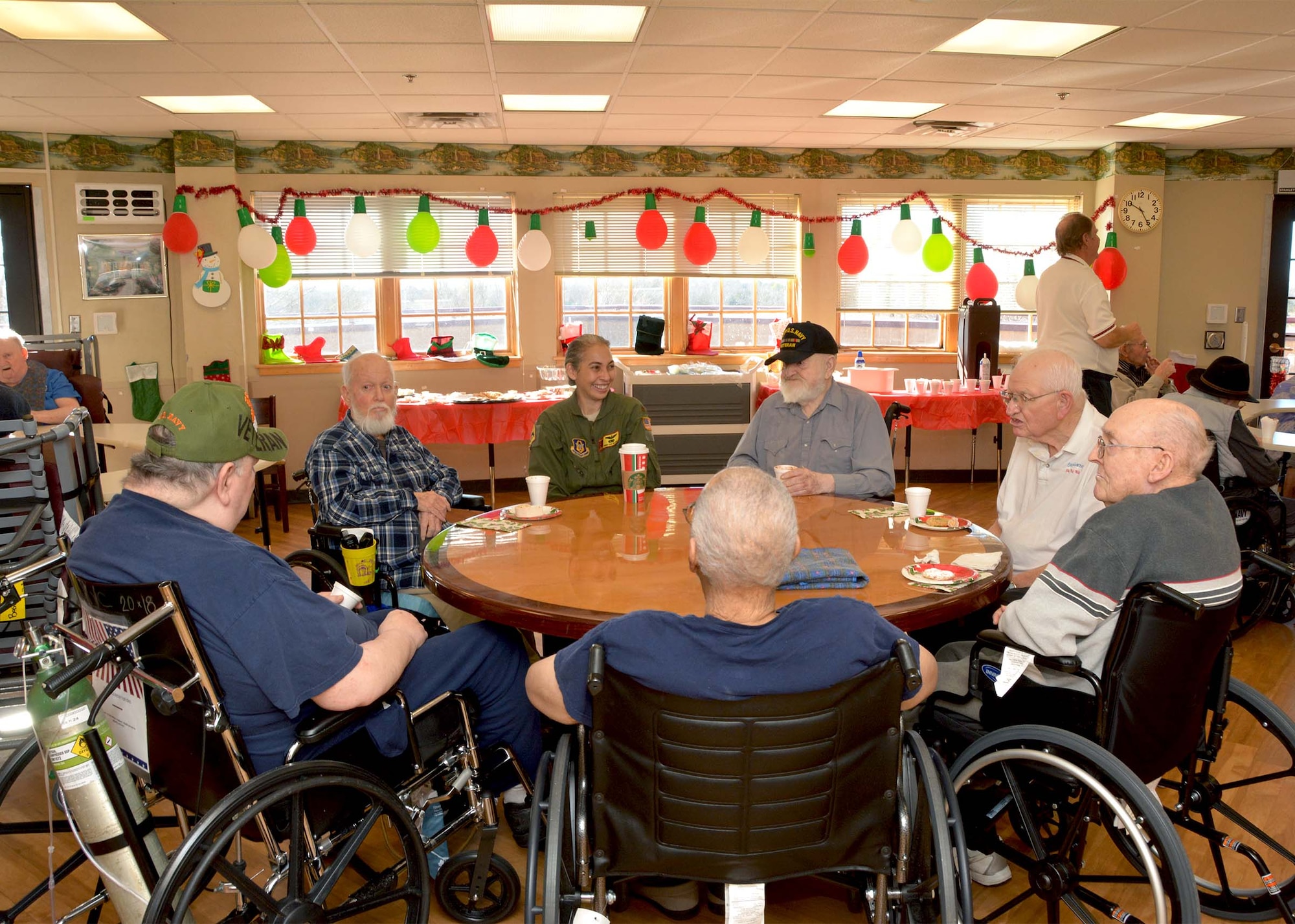Maj. Donna Williams, 465th Air Refueling Squadron KC-135R pilot, visits with a group of veterans at the Norman Veterans Center Dec. 20, 2018, in Norman, Oklahoma. 507th Air Refueling Wing Airmen visited the veterans to deliver gifts and serve snacks for the holidays. (U.S. Air Force photo by Tech. Sgt. Samantha Mathison)