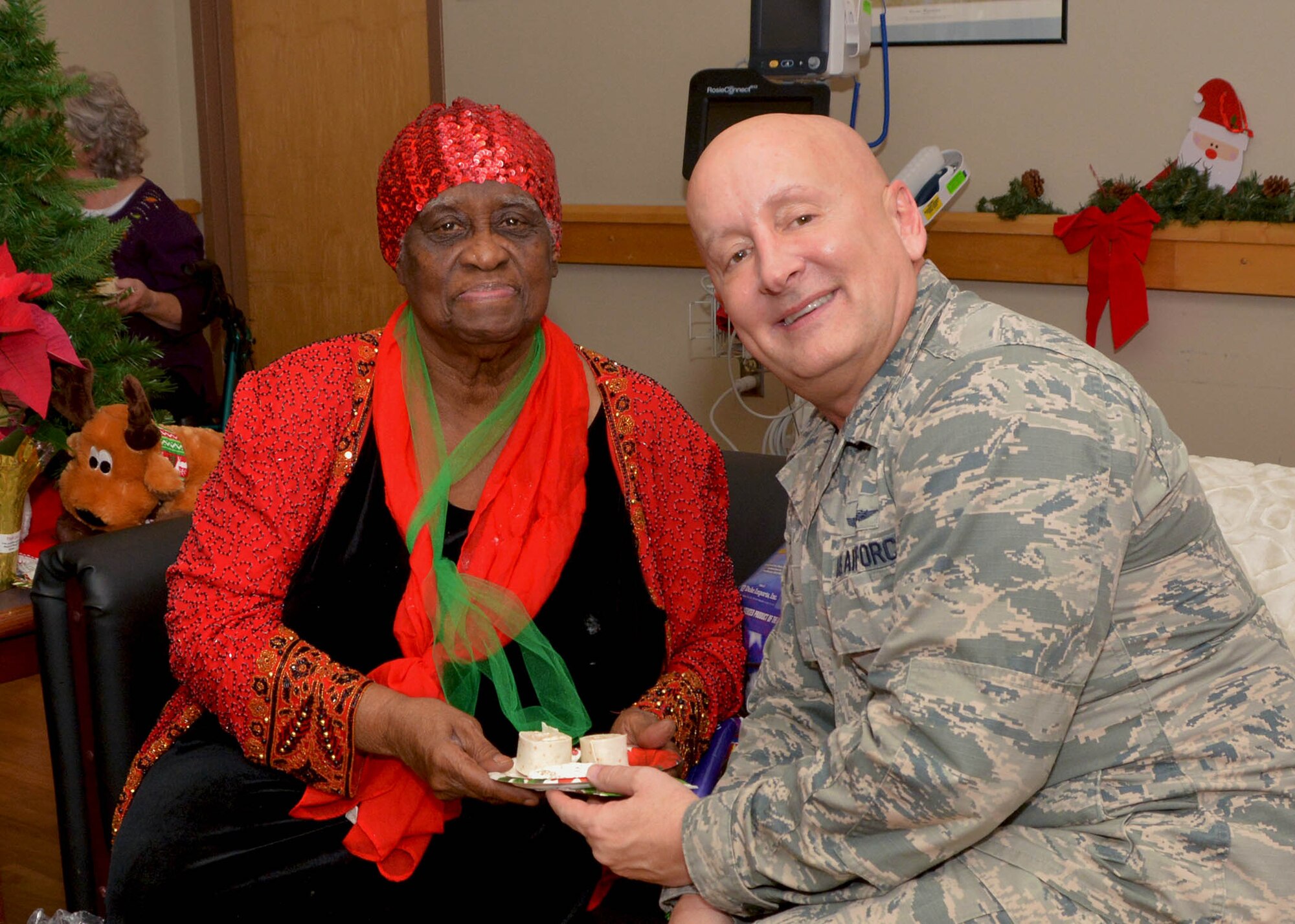 507th Mission Support Group Commander, Col. Richard Ropac, visits with a veteran Dec. 20, 2018, at the Norman Veterans Center in Norman, Oklahoma. 507th Air Refueling Wing Airmen delivered gifts and served snacks to the veterans for the holidays. (U.S. Air Force photo by Tech. Sgt. Samantha Mathison)