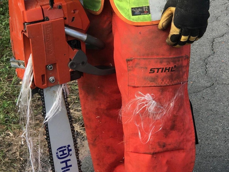 A USACE Contractor working a debris removal mission in Southwest Georgia, shown wearing safety protective chaps, following a near-miss accident with a chainsaw. Wearing chaps protected the contractor from a potentially severe leg injury.