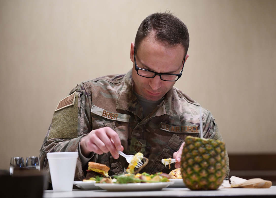 Senior Master Sgt. David Brier, the 28th Force Support Squadron senior enlisted manager, judges the three dishes presented to him during the Chef of the Quarter cook-off competition at the Raider Café on Ellsworth Air Force Base, S.D., Dec. 18, 2018. Brier judged the dishes alongside Col. Eric Hresko, the 28th Bomb Wing vice commander, and Chief Master Sgt. Justin Walker, the 28th Mission Support Group superintendent. (U.S. Air Force photo by Airman 1st Class Christina Bennett)