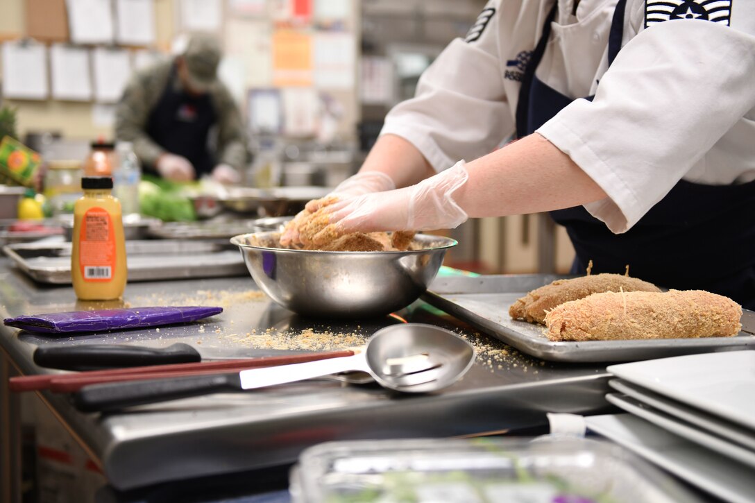 Staff Sgt. Amanda Williams, a 28th Force Support Squadron food services specialist, prepares chicken cordon bleu for the Chef of the Quarter cook-off in the Raider Café kitchen at Ellsworth Air Force Base, S.D., Dec. 18, 2019. Contestants were provided with chicken breasts and eggs, and were required to incorporate two secret ingredients. (U.S. Air Force photo by Airman 1st Class Christina Bennett)