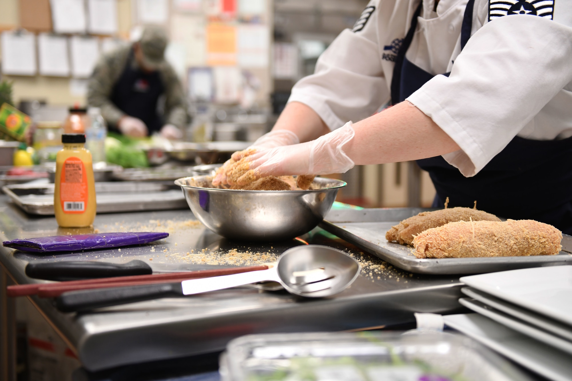 Staff Sgt. Amanda Williams, a 28th Force Support Squadron food services specialist, prepares chicken cordon bleu for the Chef of the Quarter cook-off in the Raider Café kitchen at Ellsworth Air Force Base, S.D., Dec. 18, 2019. Contestants were provided with chicken breasts and eggs, and were required to incorporate two secret ingredients. (U.S. Air Force photo by Airman 1st Class Christina Bennett)