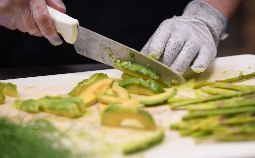 Avocado and fennel are revealed as the two secret ingredients at the beginning of the Chef of the Quarter cook-off competition at the Raider Café on Ellsworth Air Force Base, S.D., Dec. 18, 2018.  Contestants were required to incorporate the two special ingredients into their plates while sticking to the theme of “brunch.” (U.S. Air Force photo by Airman 1st Class Christina Bennett)