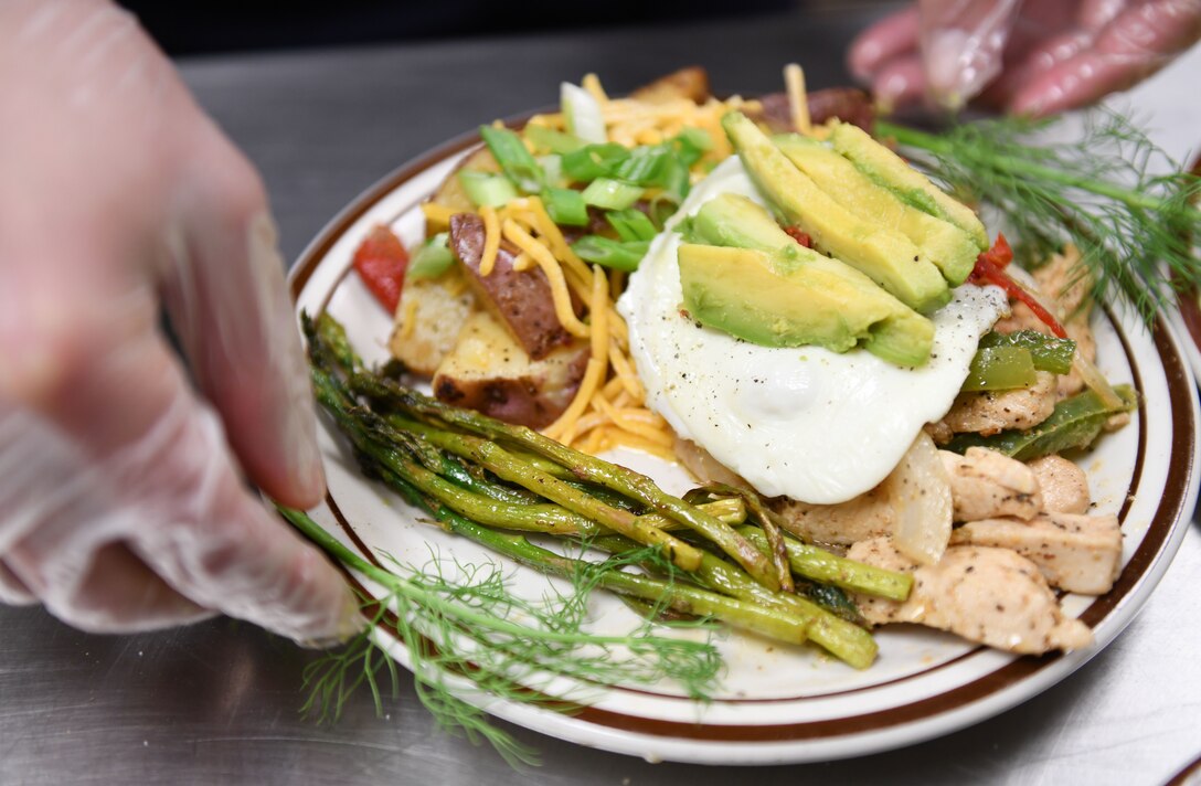 The final plate created by Airman 1st Class Alex Dogert and Tech. Sgt. David DeJesus is presented at the Chef of the Quarter cook-off competition at the Raider Café on Ellsworth Air Force Base, S.D., Dec. 18, 2018. Contestants were split into three teams and included one food service airman and one volunteer noncommissioned officer. They were required to work together to come up with a dish to present to the judges. Dogert is a 28th Force Support Squadron food services specialist and DeJesus is the 28th FSS noncommissioned officer in charge of the First Term Airman Center. (U.S. Air Force photo by Airman 1st Class Christina Bennett)