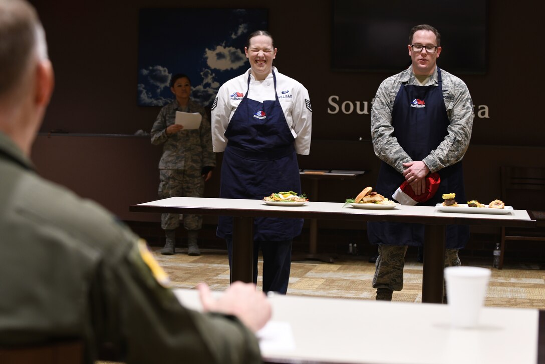 Staff Sgt. Amanda Williams, a 28th Force Support Squadron food service specialist, stands alongside her teammate, Staff Sgt. Kyle Miesbauer, a 28th FSS unit training manager, at the Chef of the Quarter cook-off competition at the Raider Café on Ellsworth Air Force Base, S.D., Dec. 18, 2018. Judges agreed that all the dishes were delicious and well-prepared, but overall Williams won the competition and was named “Chef of the Quarter.” (U.S. Air Force photo by Airman 1st Class Christina Bennett)