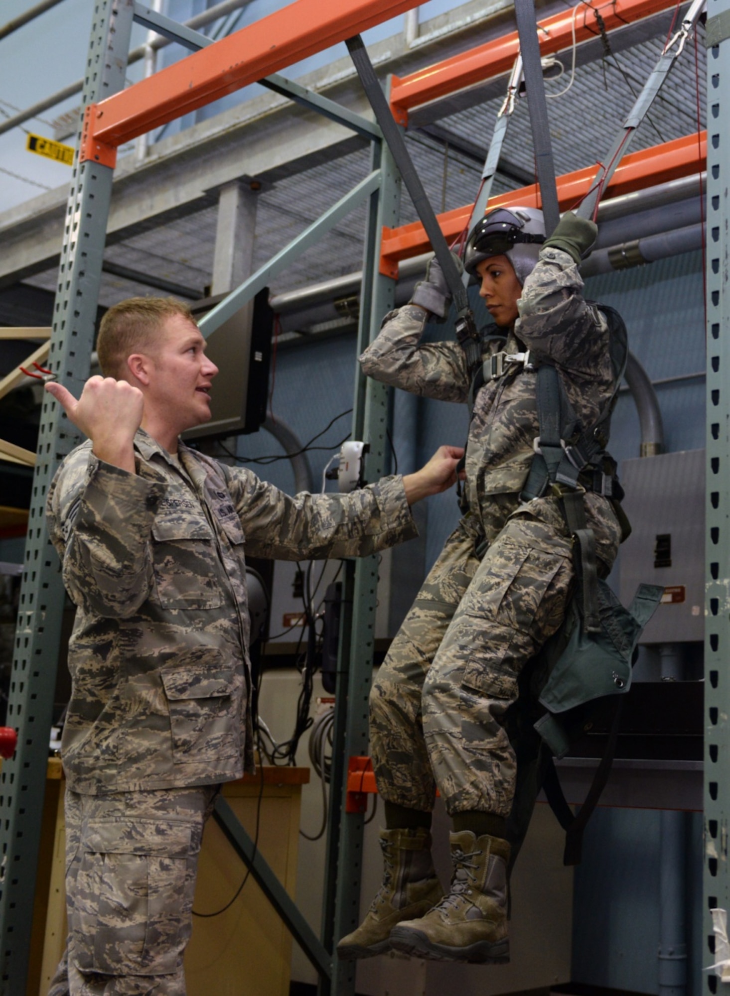 Staff Sgt. Dustin Jespersen, a 28th Operations Support Squadron survival, evasion, resistance and escape specialist, left, instructs Chief Master Sgt. Sonia Lee, the former 28th Bomb Wing command chief, on emergency parachute training at the SERE building on Ellsworth Air Force Base, S.D., Feb. 10, 2016. After being awarded the 2018 Air Rescue Association Richard T. Kight Award, Jespersen was promoted to technical sergeant as part of the Stripes for Exceptional Performers (STEP) program. (U.S. Air Force photo by Airman Donald C. Knechtel)