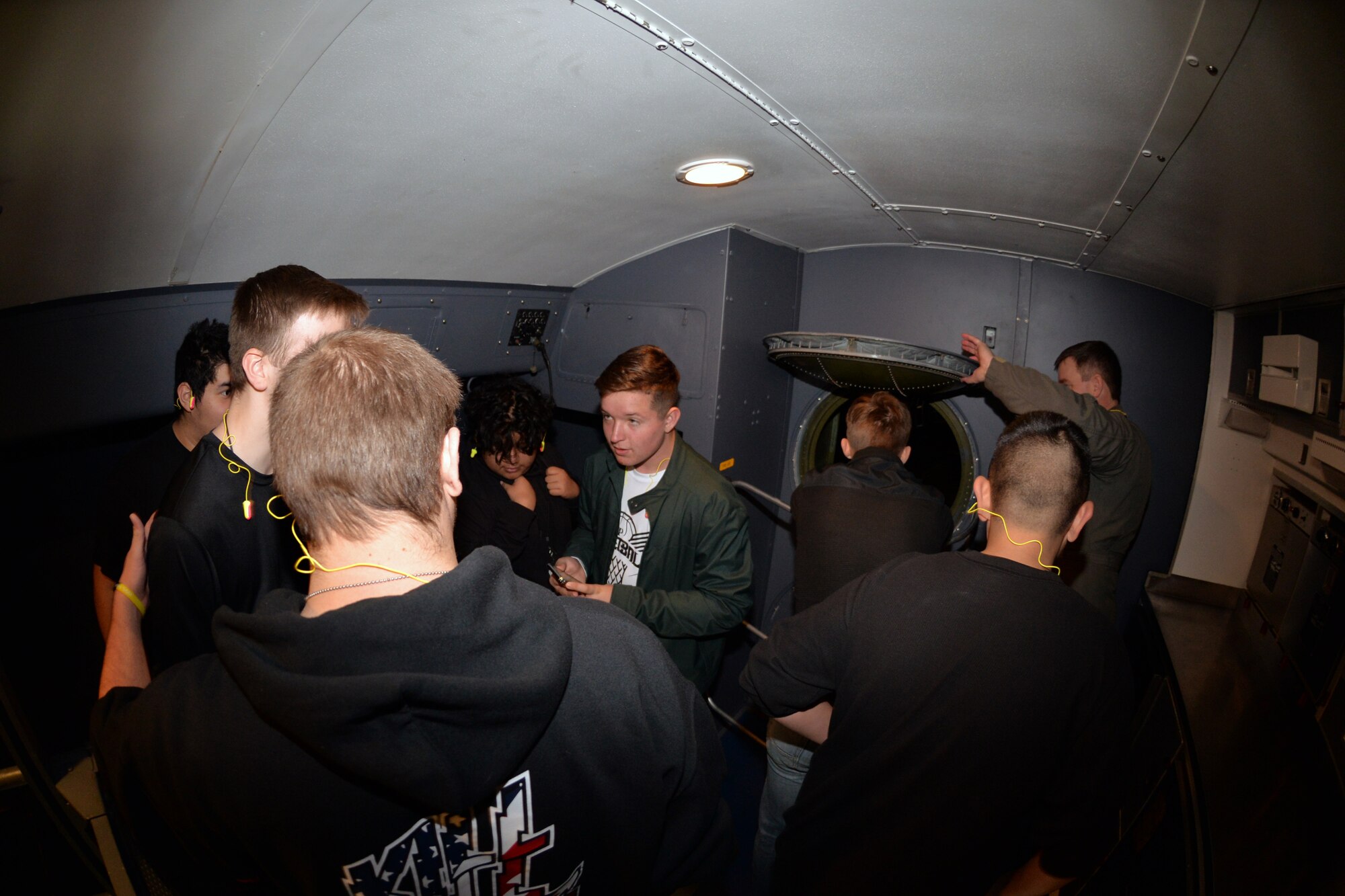 Lt. Col. Matthew Van De Walle, 356th Airlift Squadron instructor pilot, opens the aft pressure relief hatch of C-5M Super Galaxy, so students from Lytle High School can have an opportunity to view inside the bulkhead, Dec. 18, 2018 at Joint Base San Antonio-Lackland, Texas.