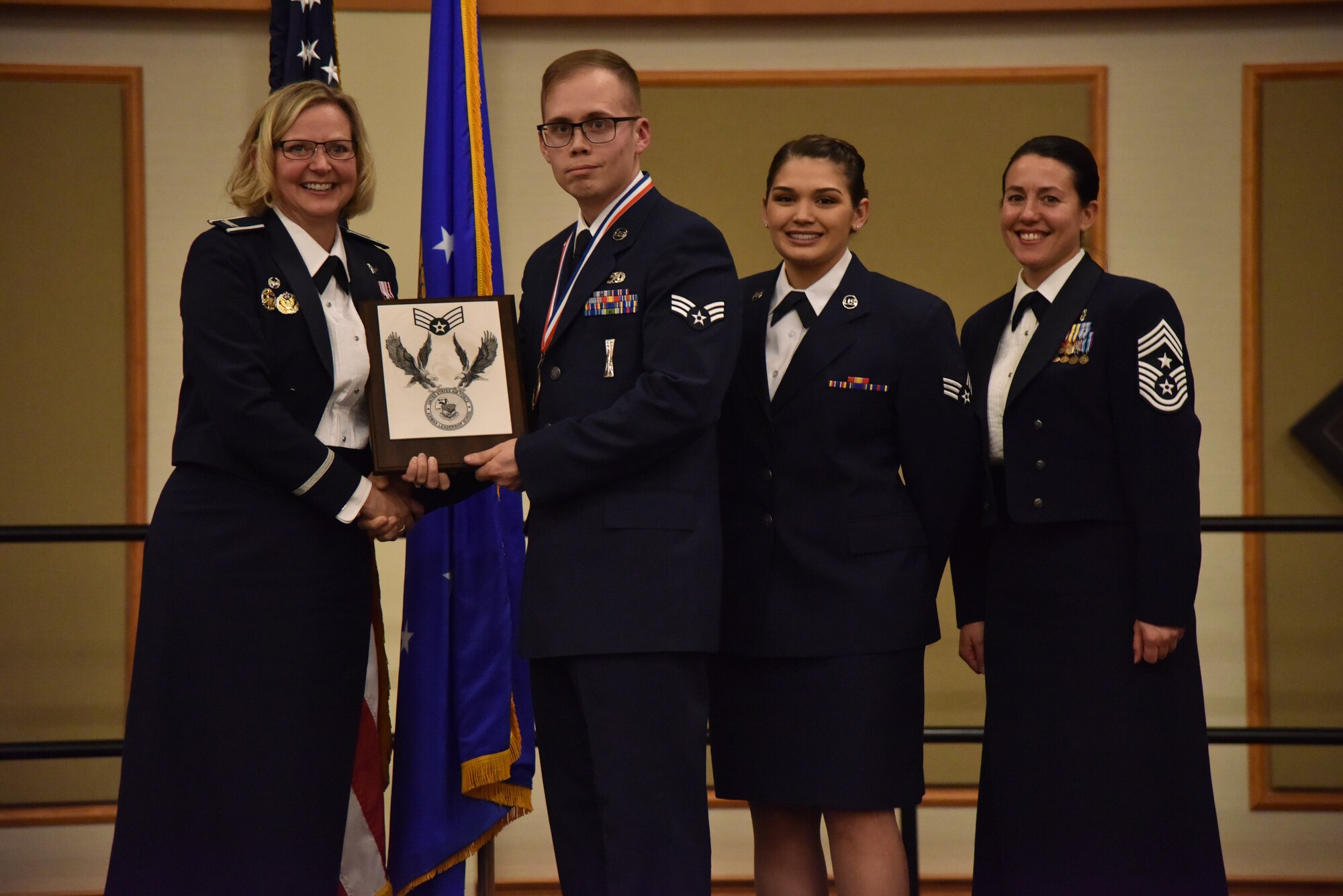 Col. Jennifer Reeves, 341st Missile Wing commander, left, Senior Airmen Norman Dyson, 341st Missile Maintenance Squadron, and Shelby Shelby, 341st Logistics Readiness Squadron and Chief Master Sgt. Eryn McElroy, 341st MW command chief, pose for a photo Dec. 19, 2018, at Malmstrom Air Force Base, Mont. Dyson received a 341st Force Support Squadron Airman Leadership School Class 19-B award for both Distinguished Graduate and Academic Achievement. (U.S. Air Force by Senior Airman Magen M. Reeves)