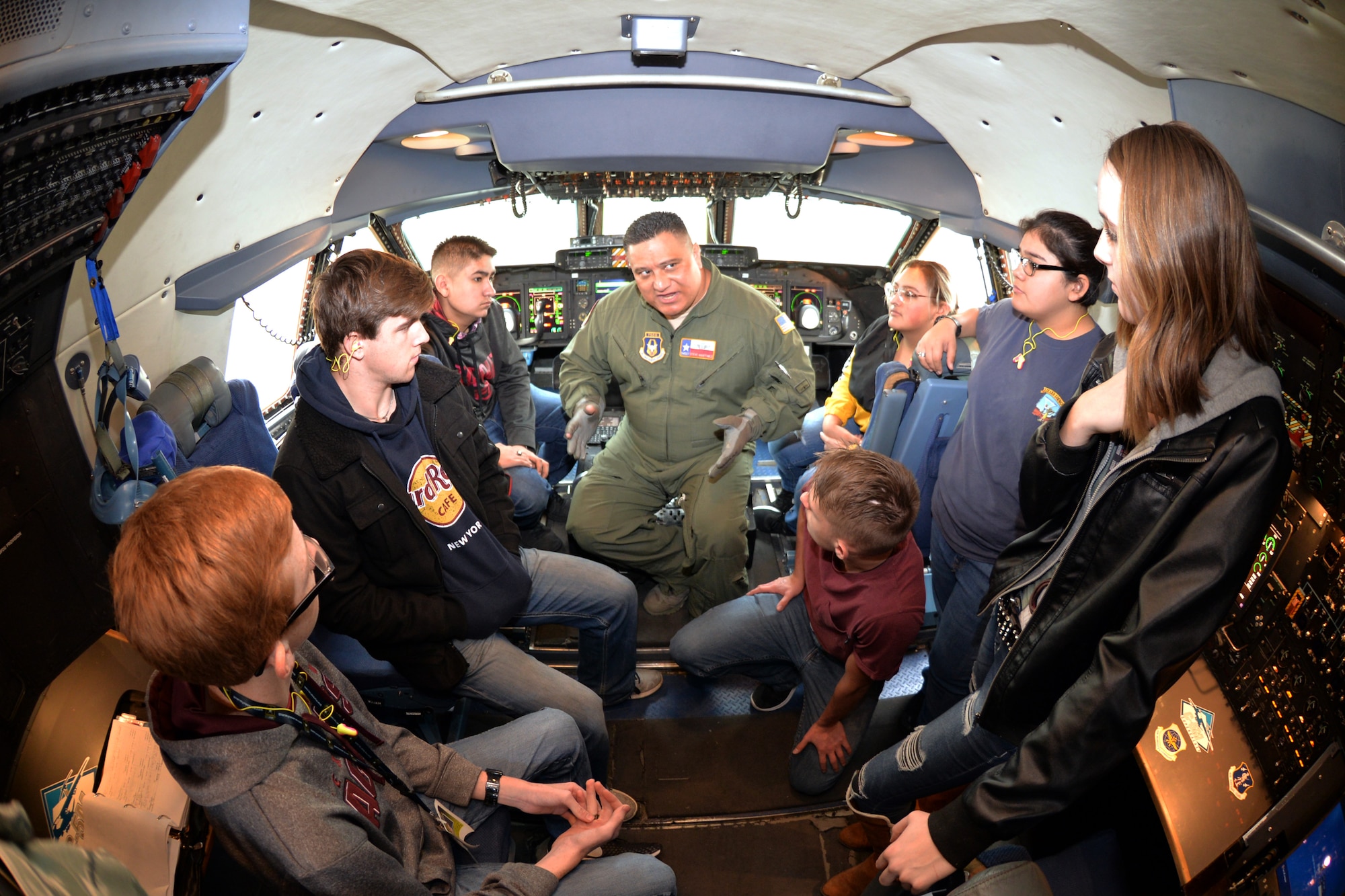 Senior Master Sgt. Steven Martinez, 433rd Operations Group flight engineer, talks to students from Lytle High School about the roles of the C-5M Super Galaxy pilot and the flight engineer during flight, Dec.18, 2018 at Joint Base San Antonio-Lackland, Texas.