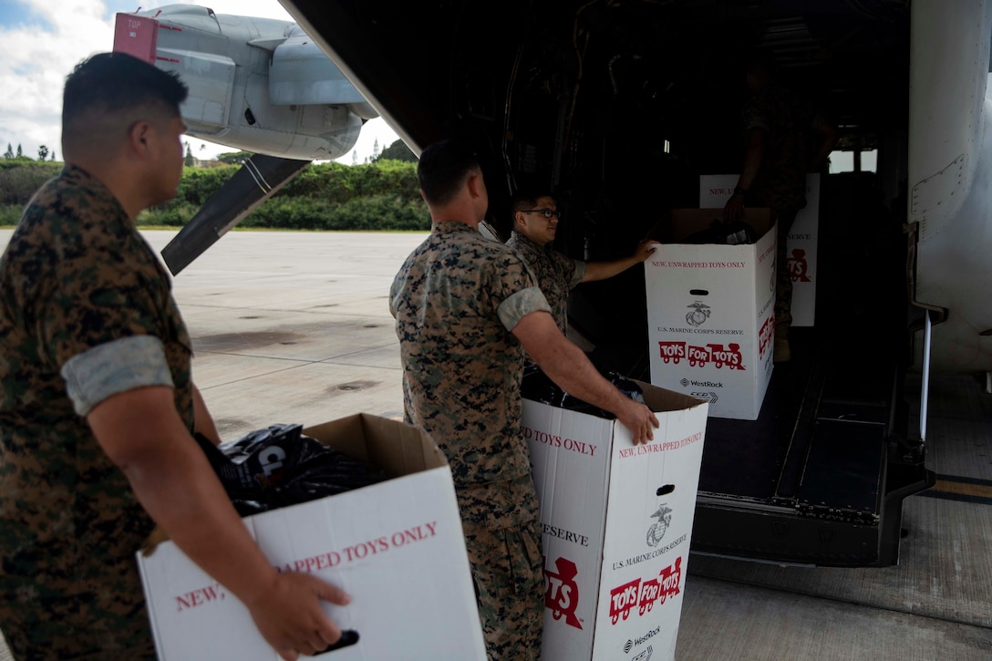 U.S. Reconnaissance Marines with Detachment 4th Force Reconnaissance Company load Marine Toys for Tots Donations into an MV-22B Osprey with Marine Medium Tiltrotor Squadron 268, Marine Aircraft Group 24, which will be donated to the Salvation Army Centers on the island of Maui, Marine Corps Air Station Kaneohe Bay, Dec. 20, 2018. The mission of the Marine Toys for Tots Program is to collect new unwrapped toys and distribute those toys to less fortunate children at Christmas. Through the gift of a new toy, Marine Toys for Tots Program help bring the joy of Christmas and send a message of hope to America's less fortunate children. (U.S. Marine Corps Photo by Sgt. Alex Kouns)