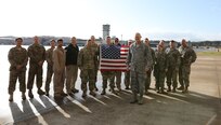 Joint Task Force Civil Support members pose for a photo with U.S. Air Force Lt. Col. Ronald Chastain, JTF-CS Chief of Current Operations at Felker Army Airfield, Fort Eustis, Va., Dec. 21, 2018. Chastain served in the military for 37 years. He was honored by friends and co-workers on a JTF-CS exercise proof of concept operation. (DoD photo by U.S. Air Force Michael Campbell/ Released)