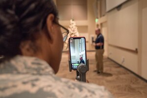 Tech. Sgt. Nichelle Anderson, Non-commissioned Officer in Charge of Command Information for the 460th Public Affairs Office at Buckley Air Force Base, Colo., monitors the Facebook live stream of Senior  Master Sgt. Israel Del Toro sharing his inspirational story at  Buckley AFB, Colo., Dec. 20 2018. Del Toro was deployed to Afghanistan in 2005 where the Humvee he was in exploded after having rolled over a landmine. (U.S. Air Force photo by Master Sgt. Eric Amidon)