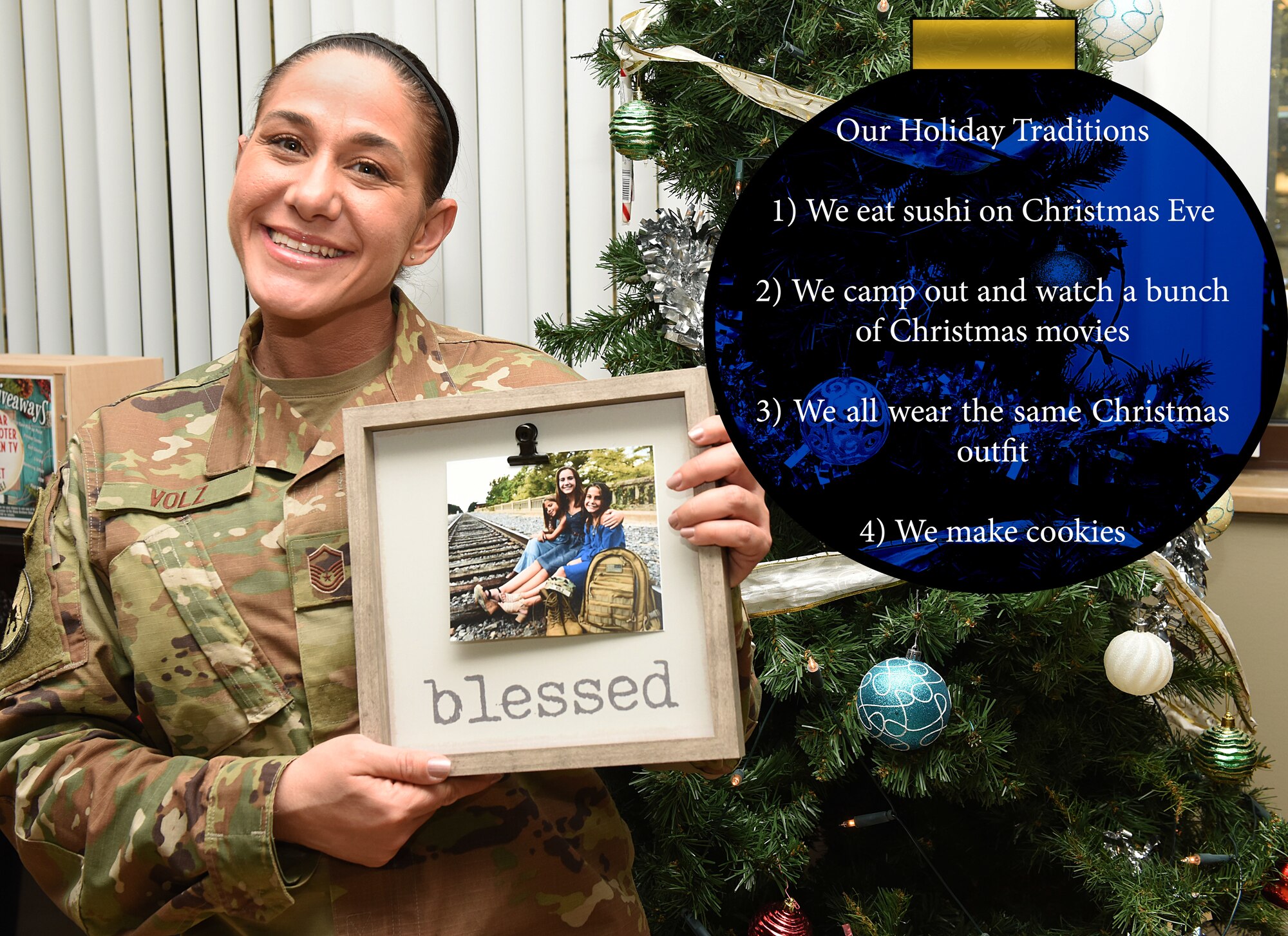 Airman holds up Christmas family photos.