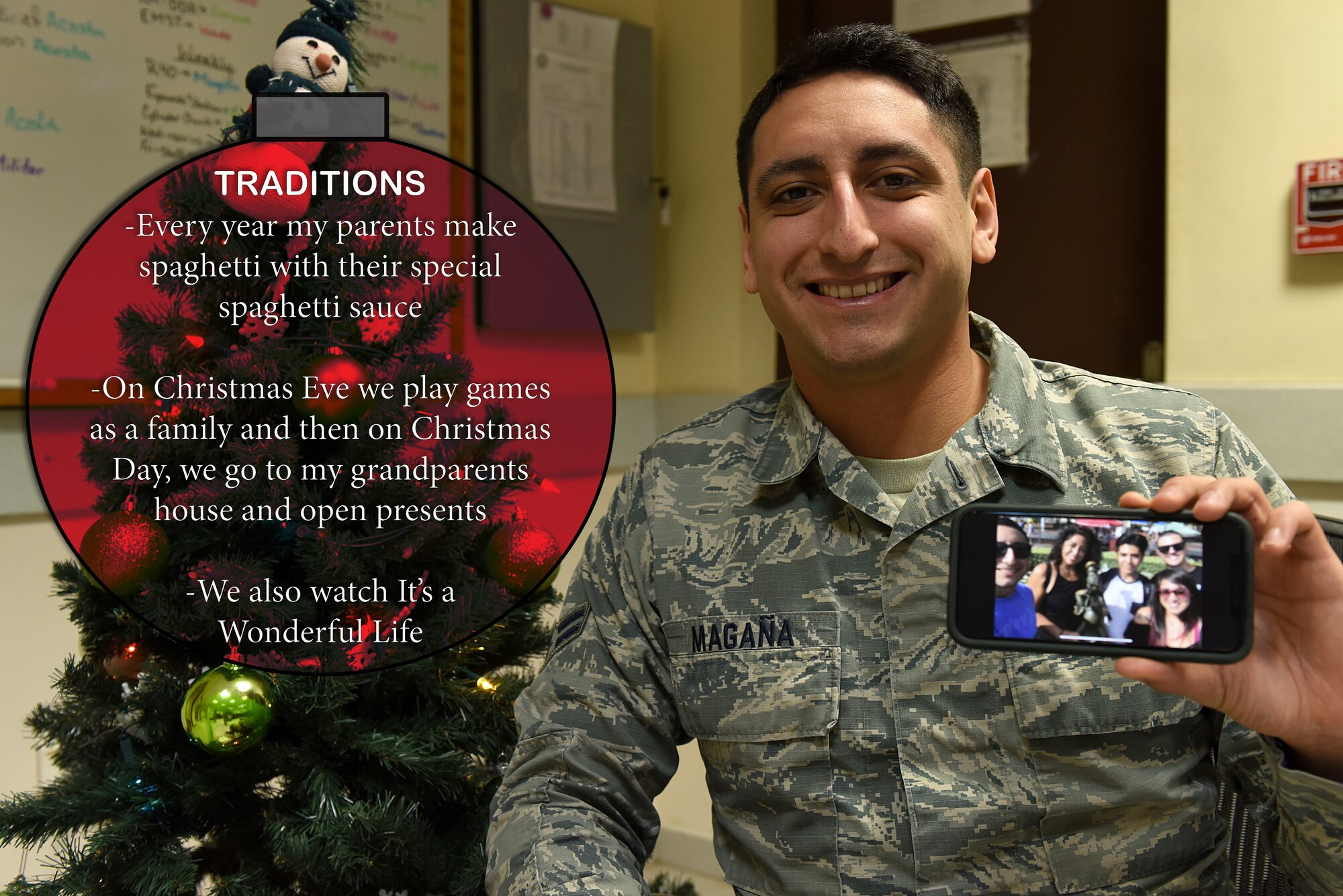 Airman holds up Christmas family photos.