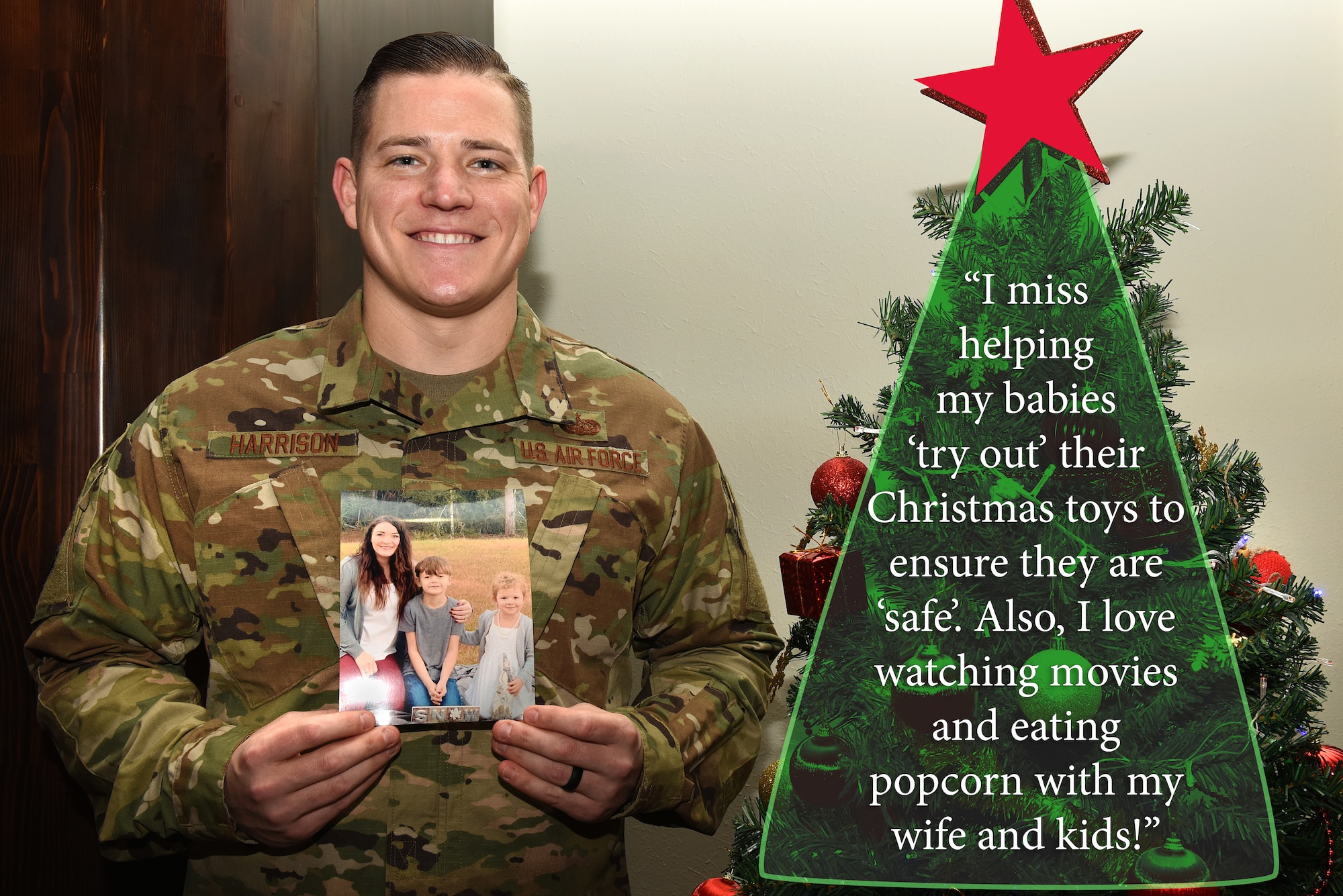 An Airman holds family Christmas photos.