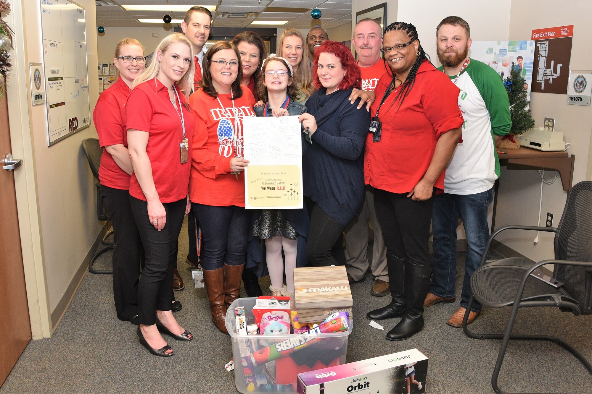 Members of the Oklahoma City Veteran Affairs Health Care System provided presents to the daughter of deployed SSgt. Joshua Gunner from the 552nd Air Control Wing, in celebration of Remember Everyone Deployed, a new program designed to recognize families of deployed members during the holidays on Dec. 19.