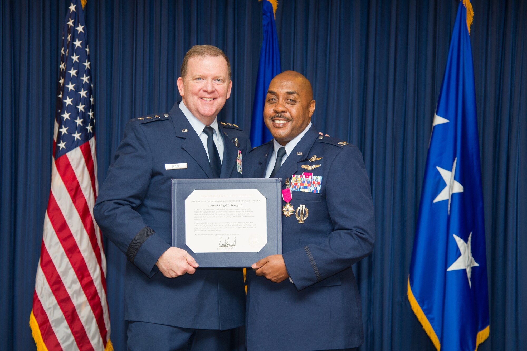Lt. Gen. Richard Scobee, Commander, Air Force Reserve Command and Chief, Air Force Reserve, presents Col. Lloyd Terry with a certificate of appreciation, Friday, December 14, at Naval Air Station Fort Worth Joint Reserve Base, Texas, culminating a 35 year career.