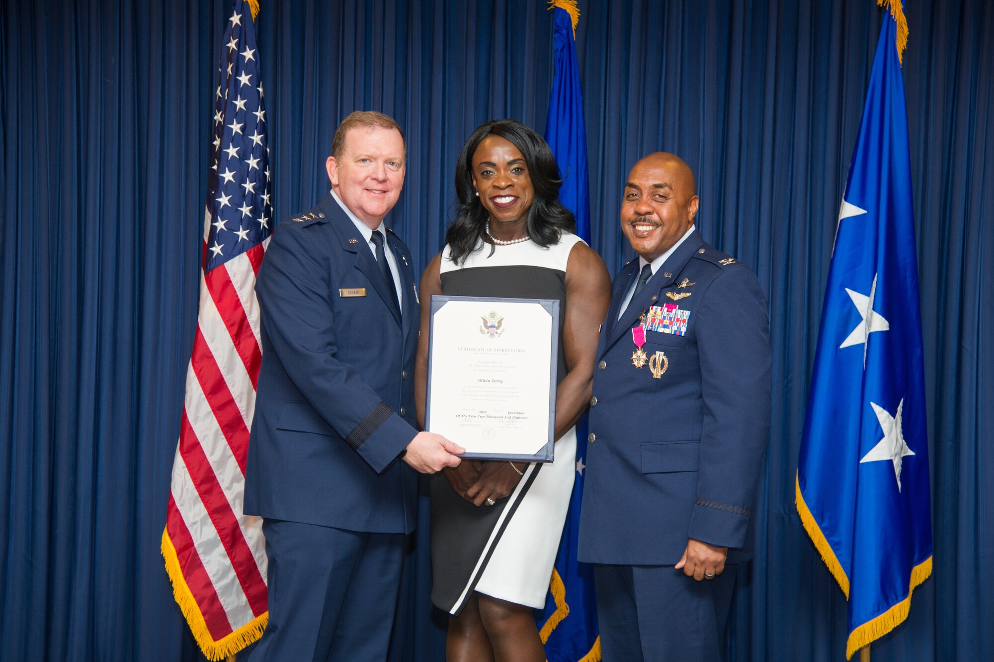 Lt. Gen. Richard Scobee, Commander, Air Force Reserve Command and Chief, Air Force Reserve, presents Mrs. Olivia Terry with certificate of appreciation, Friday, December 14, at Naval Air Station Fort Worth Joint Reserve Base, Texas,