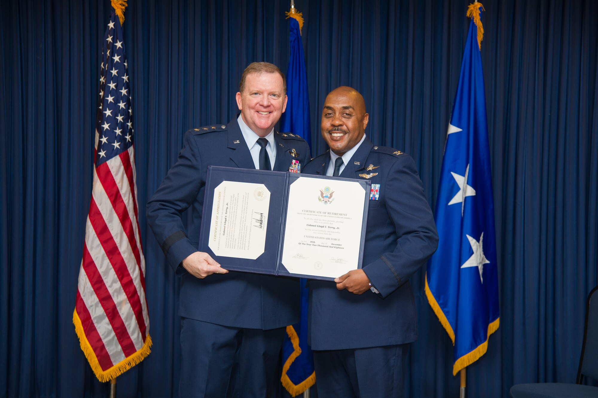 Lt. Gen. Richard Scobee, Commander, Air Force Reserve Command and Chief, Air Force Reserve, presents Col. Lloyd Terry with his retirement certificate and certificate of appreciation, Friday, December 14, at Naval Air Station Fort Worth Joint Reserve Base, Texas, culminating a 35 year career.