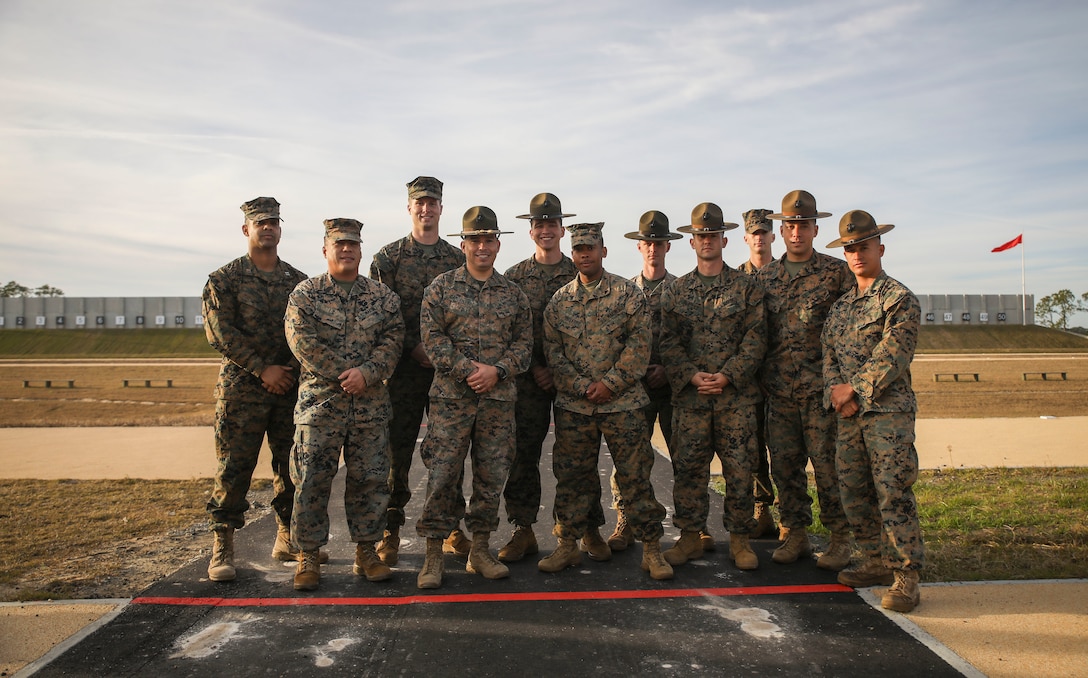 Members of the Marine Corps Recruit Depot Parris Island shooting team pose for a photo on the newly-renovated Inchon Rifle Range on Parris Island, S.C. Dec. 18, 2018. After more than two years of renovation and reconstruction, the 50 lane firing range was rebuilt to include new impact and side safety berms, newly paved firing lines, roads, storm water collection and management systems, and irrigation systems. 

(U.S. Marine Corps photo by Sgt. Dana Beesley/Released)