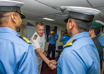 Capt. Dennis Jacko, from Sayerville, N.J., commanding officer of the San Antonio-class amphibious transport dock ship USS Anchorage (LPD 23), greets distinguished visitors from the Indian military during a port visit to Visakhapatnam, India, while on a deployment of the Essex Amphibious Ready Group (ARG) and 13th MEU. The Essex ARG/ 13th MEU is a capable and lethal Navy-Marine Corps team deployed to the 7th fleet area of operations to support regional stability, reassure partners and allies and maintain a presence postured to respond to any crisis ranging from humanitarian assistance to contingency operations.