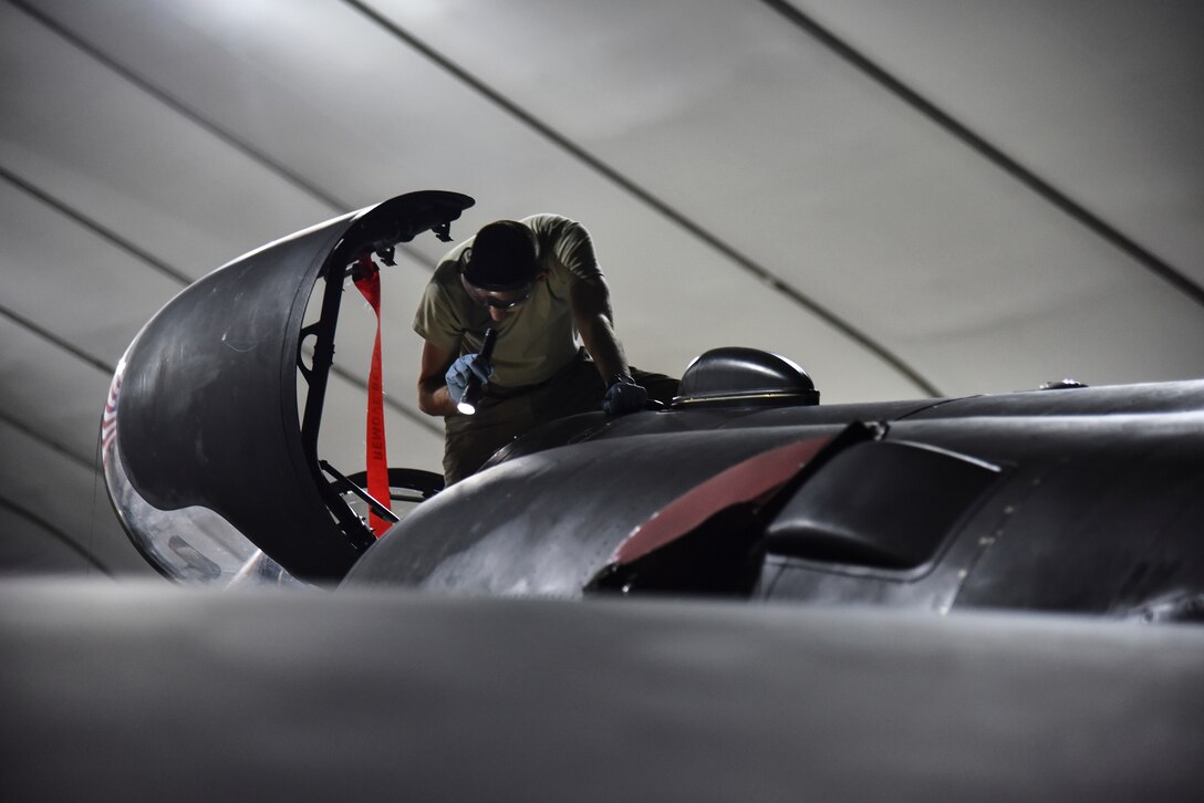 U.S. Air Force Senior Airman Chad Taylor, 380th Expeditionary Aircraft Maintenance Squadron U-2 Dragon Lady crew chief, reads a technical order at Al Dhafra Air Base, United Arab Emirates, Dec. 18, 2018. The crew chief’s extensive list of responsibilities including for pre-, post- and thru-flight checks, and well as various inspections, allows them to fully understand their vital role, making them jacks-of-all-trades when it comes to repairing the aircraft. (U.S. Air Force photo by Senior Airman Mya M. Crosby)