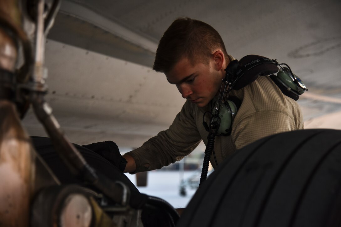 U.S. Air Force Senior Airman Gilbert, 380th Expeditionary Aircraft Maintenance Squadron E-3 AWACS Sentry crew chief, inspects a tire of a KC-10 during a pre-flight inspection at Al Dhafra Air Base, United Arab Emirates, Dec. 20, 2018. The crew chief’s extensive list of responsibilities including for pre-, post- and thru-flight checks, and well as various inspections, allows them to fully understand their vital role, making them jacks-of-all-trades when it comes to repairing the aircraft. (U.S. Air Force photo by Senior Airman Mya M. Crosby)