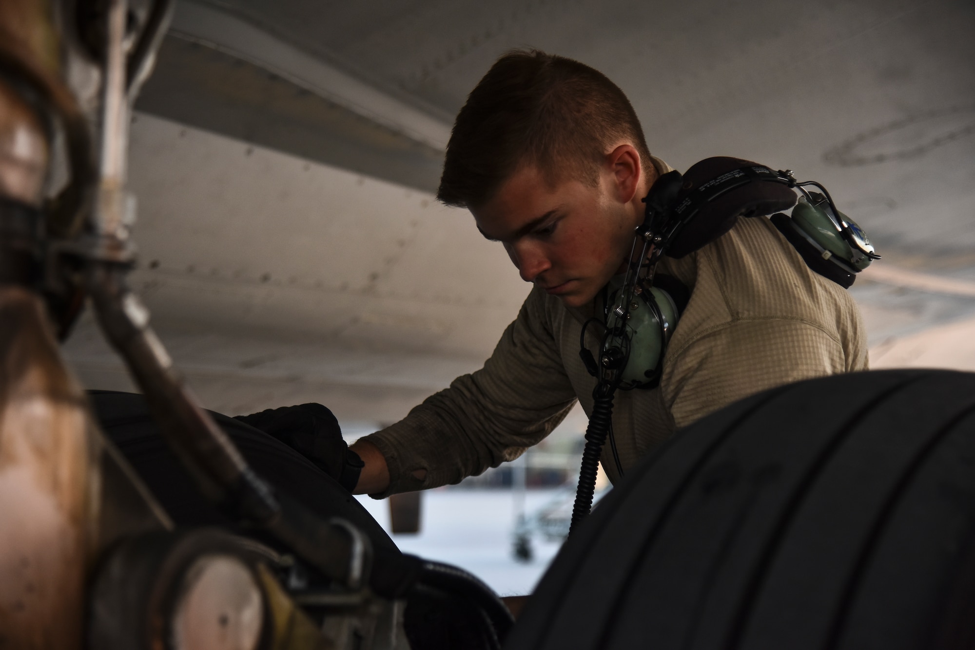 U.S. Air Force Senior Airman Gilbert, 380th Expeditionary Aircraft Maintenance Squadron E-3 AWACS Sentry crew chief, inspects a tire of a KC-10 during a pre-flight inspection at Al Dhafra Air Base, United Arab Emirates, Dec. 20, 2018. The crew chief’s extensive list of responsibilities including for pre-, post- and thru-flight checks, and well as various inspections, allows them to fully understand their vital role, making them jacks-of-all-trades when it comes to repairing the aircraft. (U.S. Air Force photo by Senior Airman Mya M. Crosby)