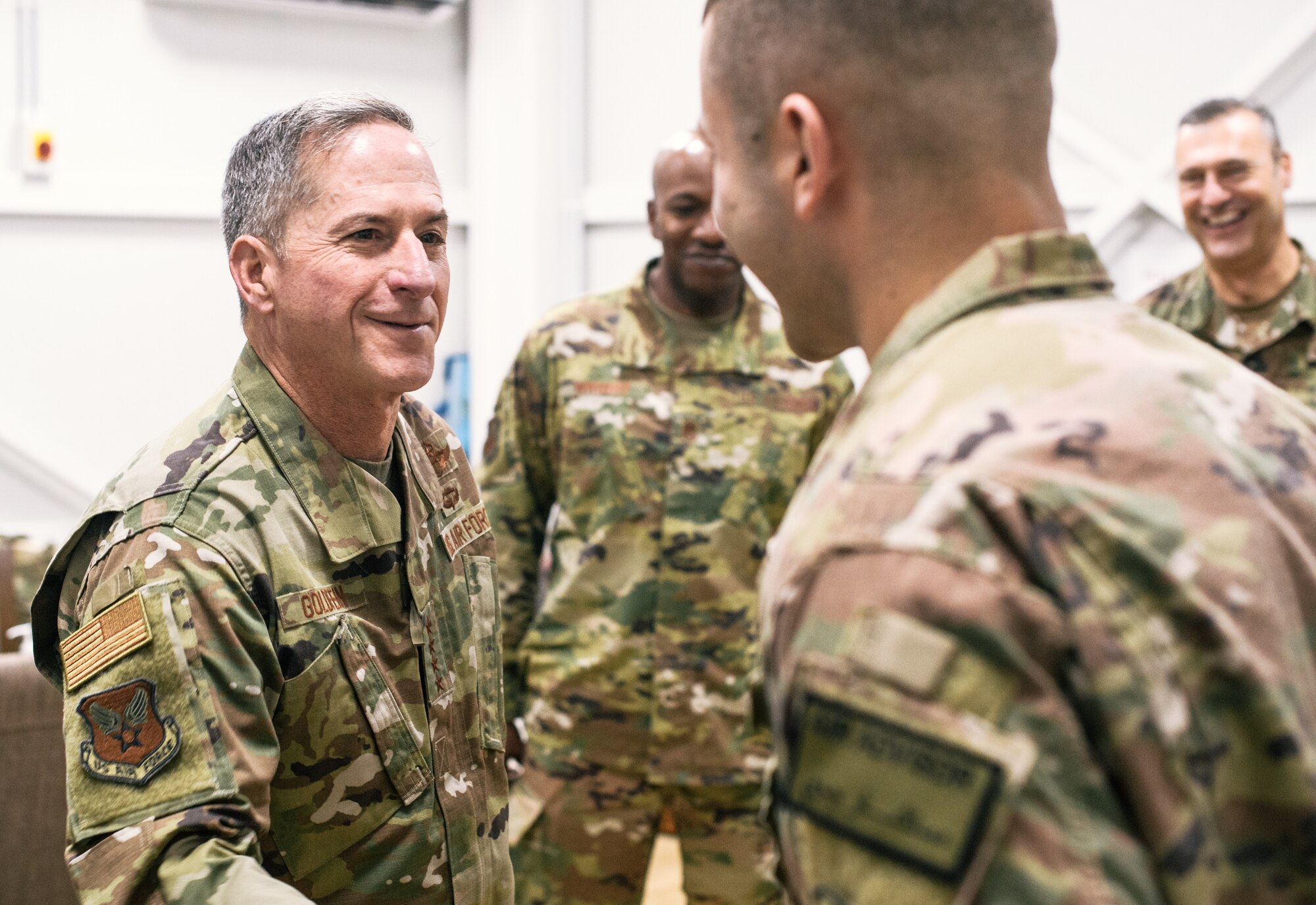 Air Force Chief of Staff Gen. David L. Goldfein congratulates a deployed Airman for superb performance at an undisclosed location in Southwest Asia, Dec. 22, 2018. Goldfein, Chief Master Sgt. of the Air Force Kaleth O. Wright, and U.S. Air Forces Central Command commander Lt. Gen. Joseph Guastella traveled throughout U.S. Central Command's area of responsibility thanking Airmen for their sacrifice, recognizing outstanding performers and listening to Airmen during the holiday season. (U.S. Air Force photo by Staff Sgt. Jordan Castelan)