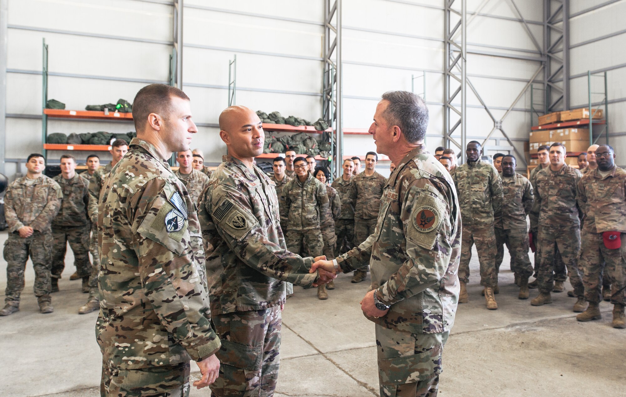 Air Force Chief of Staff Gen. David L. Goldfein congratulates a deployed Airman for outstanding performance at an undisclosed location in Southwest Asia, Dec. 22, 2018. Goldfein traveled throughout the U.S. Central Command's area of responsibility recognizing the selfless service of Airmen and reminding them to take ownership of their Air Force every single day. (U.S. Air Force photo by Staff Sgt. Jordan Castelan)