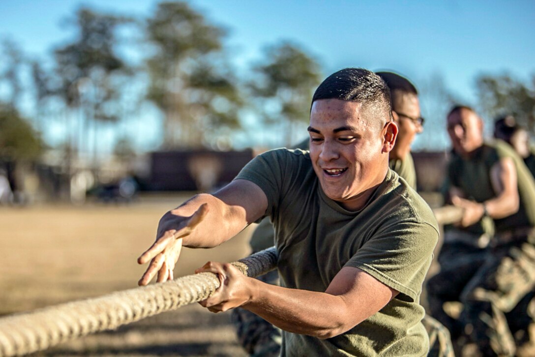 Marines participate in a tug of war.