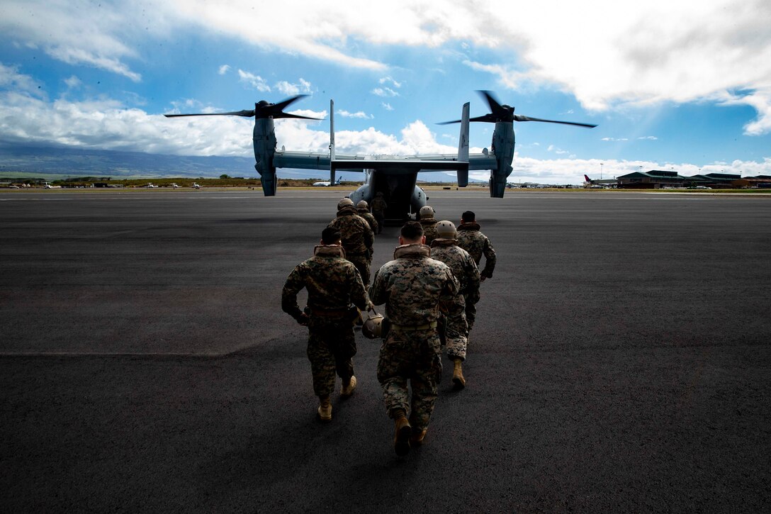 U.S. Reconnaissance Marines with Detachment 4th Force Reconnaissance Company returns to an MV-22B Osprey with Marine Medium Tiltrotor Squadron 268, Marine Aircraft Group 24, after transporting Marine Toys for Tots Donations from Marine Corps Base Hawaii to the Salvation Army Centers on the island of Maui, Dec. 20, 2018. The mission of the Marine Toys for Tots Program is to collect new unwrapped toys and distribute those toys to less fortunate children at Christmas. Through the gift of a new toy, Marine Toys for Tots Program help bring the joy of Christmas and send a message of hope to America's less fortunate children.
