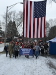 Retired New York Army National Guard Sgt. 1st Class Arthur Coon, center in red jacket, steps off for the 15th annual Christmas Eve Road March in Glens Falls, N.Y., Dec. 24, 2018. Coon has organized the annual event to honor deployed service members since 2004 when Soldiers from the New York Army National Guard were deployed to Iraq.