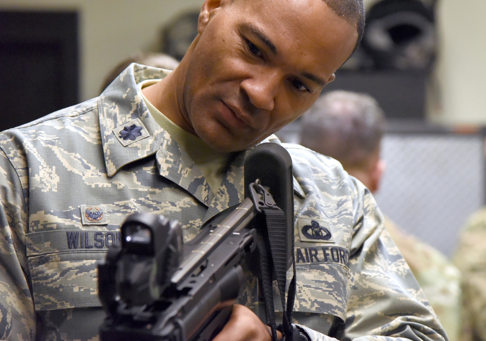 U.S. Air Force Lt. Col. Billy Wilson, 334th Training Squadron commander, inspects an M-320 grenade launcher during the 81st Security Forces Squadron Day In The Life Of A Defender event at Keesler Air Force Base, Mississippi, Dec. 18, 2018. The event, which was the kick-off for the Year Of The Defender, allowed the 81st SFS to showcase their training and mission capabilities to Keesler leadership. (U.S. Air Force photo by Kemberly Groue)