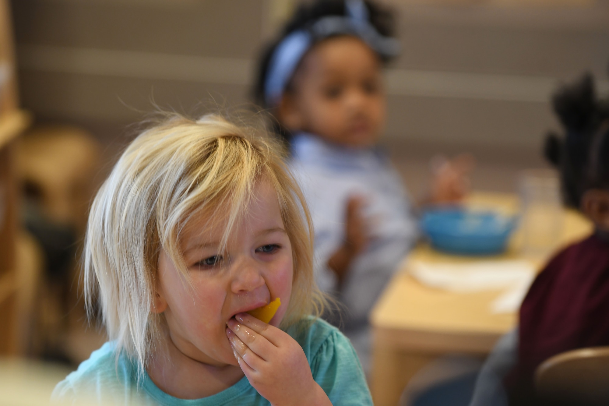 Jaidyn Mastalski, the daughter of 1st Lt. Michael Mastalski, a 28th Maintenance Squadron avionics officer, eats peaches and yogurt during snack time at the McRaven Child Development Center on Ellsworth Air Force Base, S.D., Dec. 6, 2018. The children at the CDC are provided with a nutritious breakfast, lunch and snacks throughout the day. (U.S. Air Force photo by Airman 1st Class Christina Bennett)