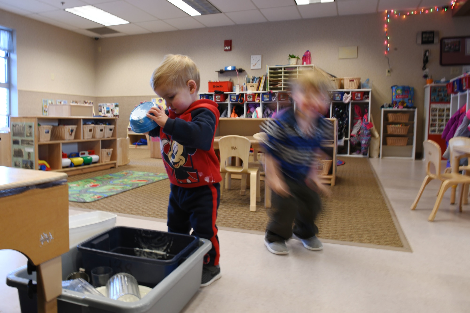 Jackson Scott, the son of Staff Sgt. Matthew Scott a 372nd Training Squadron professional military education instructor, cleans his bowl after snack time at the McRaven Child Development Center on Ellsworth Air Force Base, S.D., Dec. 6, 2018. The afternoon is not just fun and games; the toddlers are taught to wash their hands and clean up their play spaces. (U.S. Air Force Photo by Airman 1st Class Christina Bennett)