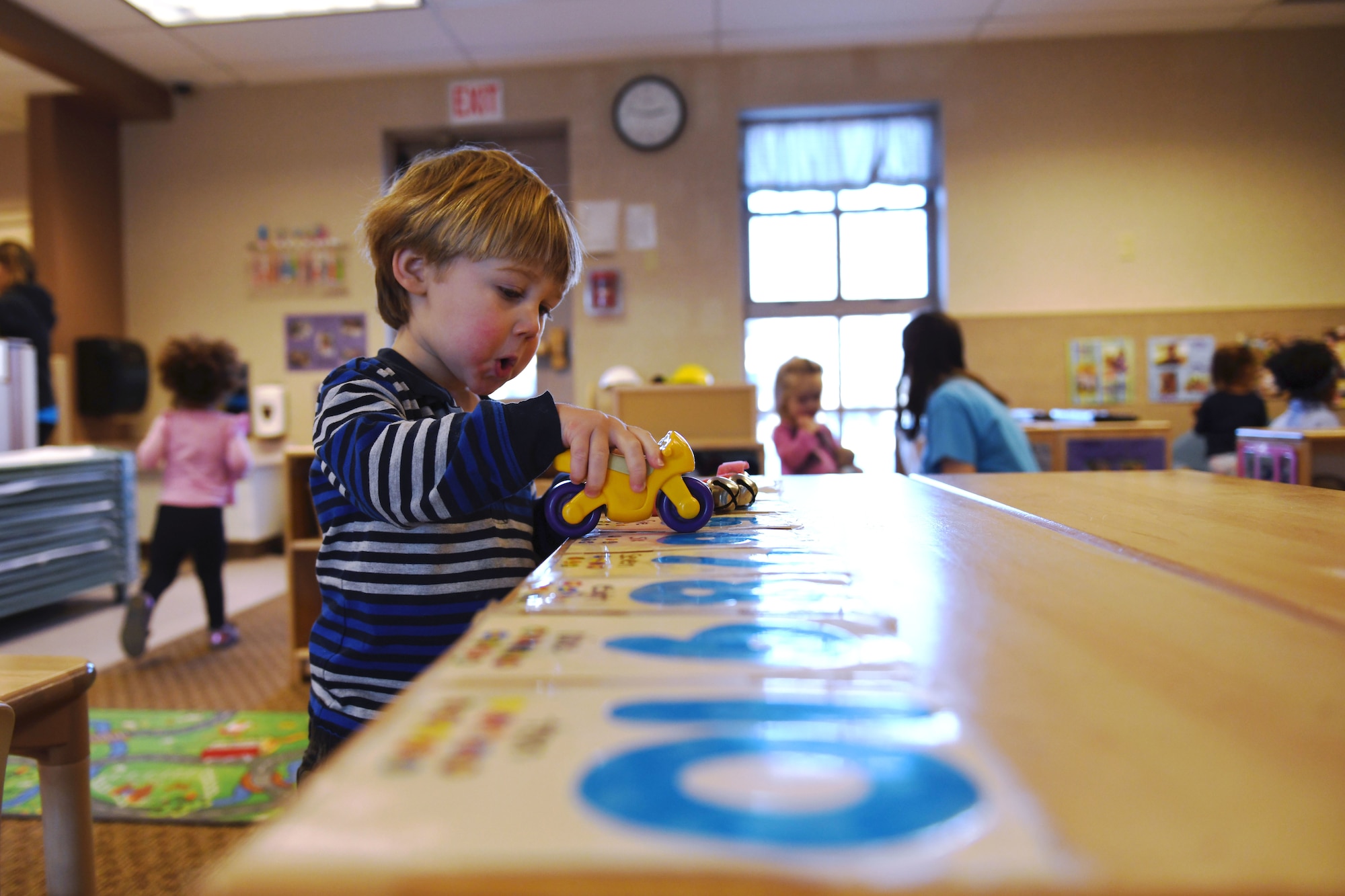 Fox Brookins, the son of Capt. Ryan K. Brookins, the 34th Bomb Squadron assistant director of operations, plays during open playtime in room 138 at the McRaven Child Development Center on Ellsworth Air Force Base, S.D., Dec. 6, 2018. Open playtime gives children a chance to play creatively while developing their motor skills and hand-eye coordination. (U.S. Air Force photo by Airman 1st Class Christina Bennett)