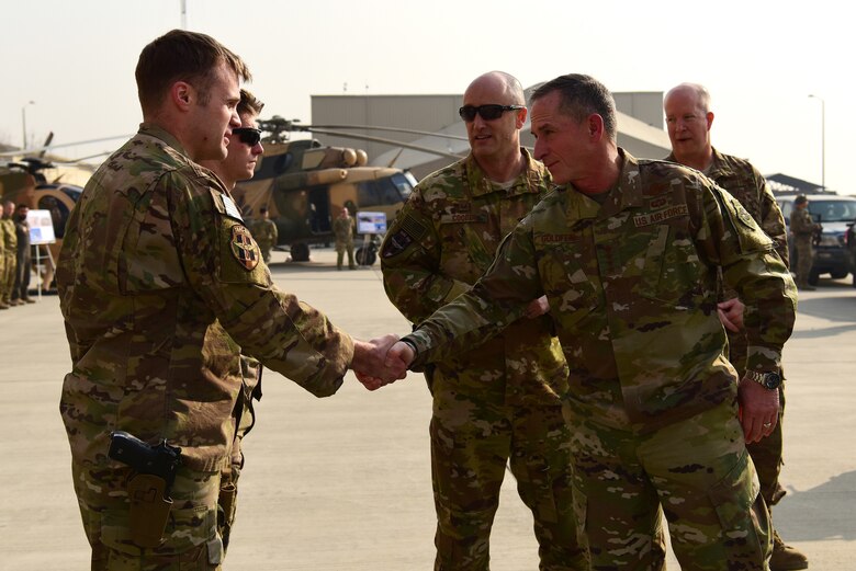 Air Force Chief of Staff Gen. David L. Goldfein coins Capt. John Newman in Kabul, Afghanistan, on Dec. 24, 2018. Newman was one of five Train Advise Assist Command-Air members who  received a coin from Goldfein for excellent performance in executing the TAAC-A mission to train, advise, and assist Afghan partners to develop a professional, capable, and sustainable air force . (U.S Air Force photo by Staff Sgt. Ariel D. Partlow)