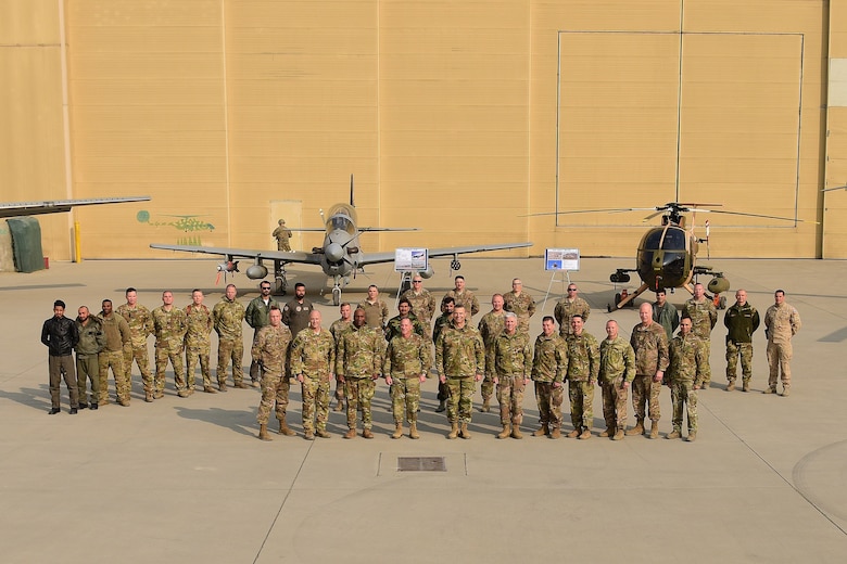 Air Force Chief of Staff Gen. David L. Goldfein and Chief Master Sgt. of the Air Force Kaleth O. Wright stand with Train Advise Assist Command-Air members in front of Afghan Air Force aircraft at Kabul, Afghanistan, Dec. 24, 2018. Goldfein and Wright visited Forward Operating Base Oqab as part of a holiday battlefield rotation to speak with deployed Airmen. (U.S. Air Force photo by Staff Sgt. Ariel D. Partlow)