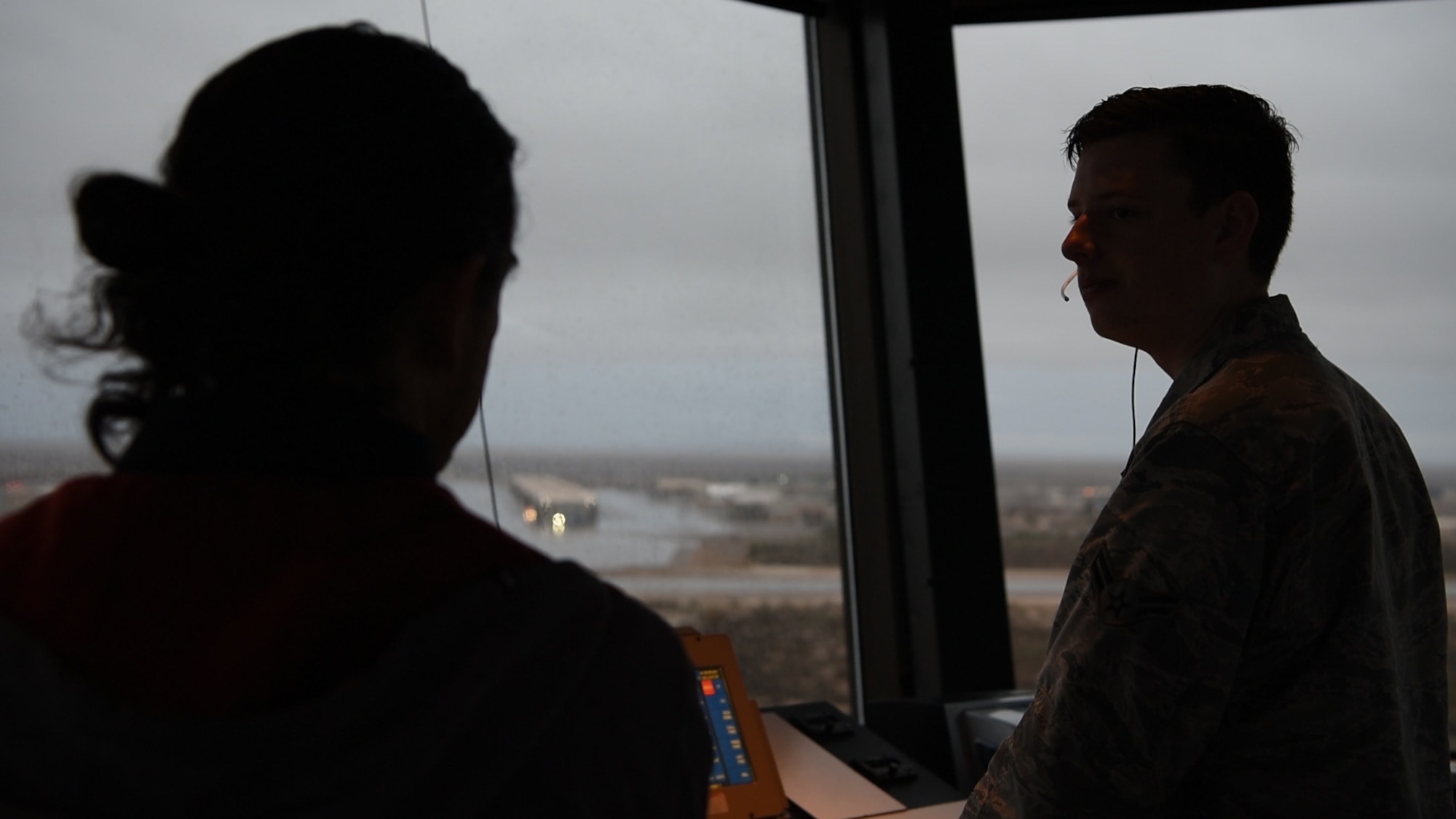(From left to right) Edward Morse, 54th Operations Support Squadron air traffic controller, observes as Airman 1st Class Joseph Pannetti, 54th OSS air traffic control trainee, gives a traffic call, Dec. 18, on Holloman Air Force Base, N.M. Controllers are not authorized to give traffic calls without at least a 5-level air traffic controller observing them (U.S. Air Force photo by Staff Sgt. BreeAnn Sachs)