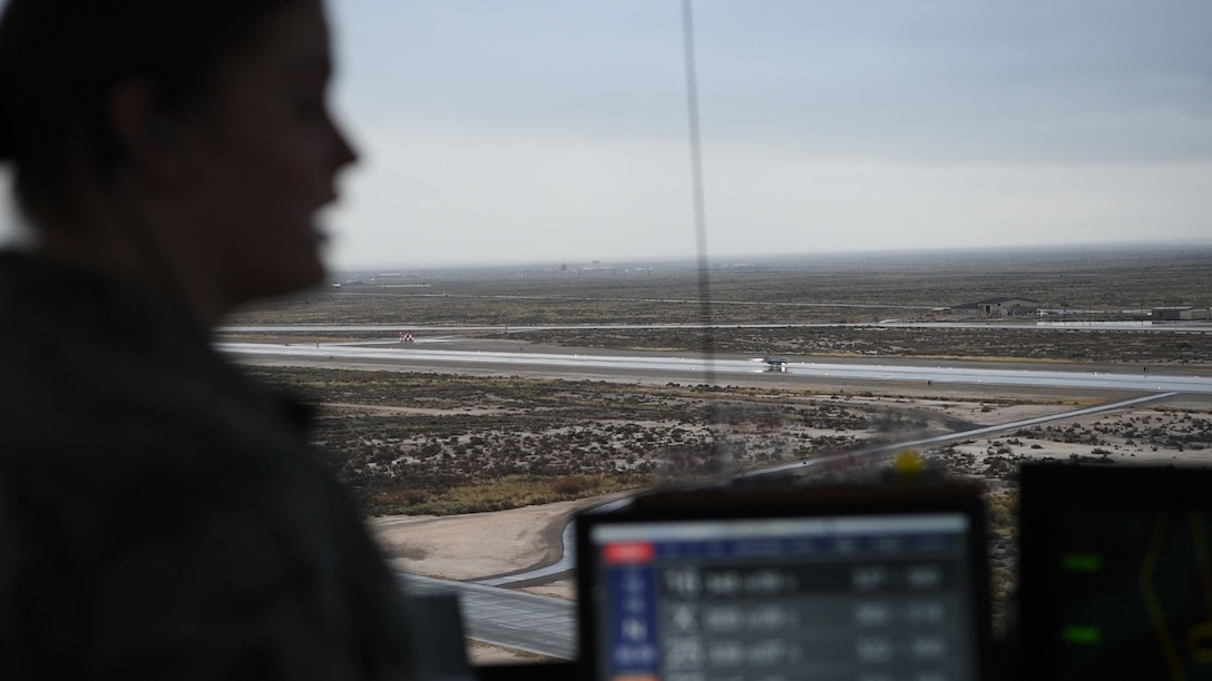 Senior Airman Kaitlyn Hopp, 54th Operations Support Squadron air traffic controller, gives a traffic call as an F-16 Fighting Falcon takes off, Dec. 18, 2018, on Holloman Air Force Base, N.M. Before an F-16 can take off or land they must be in contact with the air traffic control tower to ensure the runway is clear. (U.S. Air Force photo by Staff Sgt. BreeAnn Sachs)