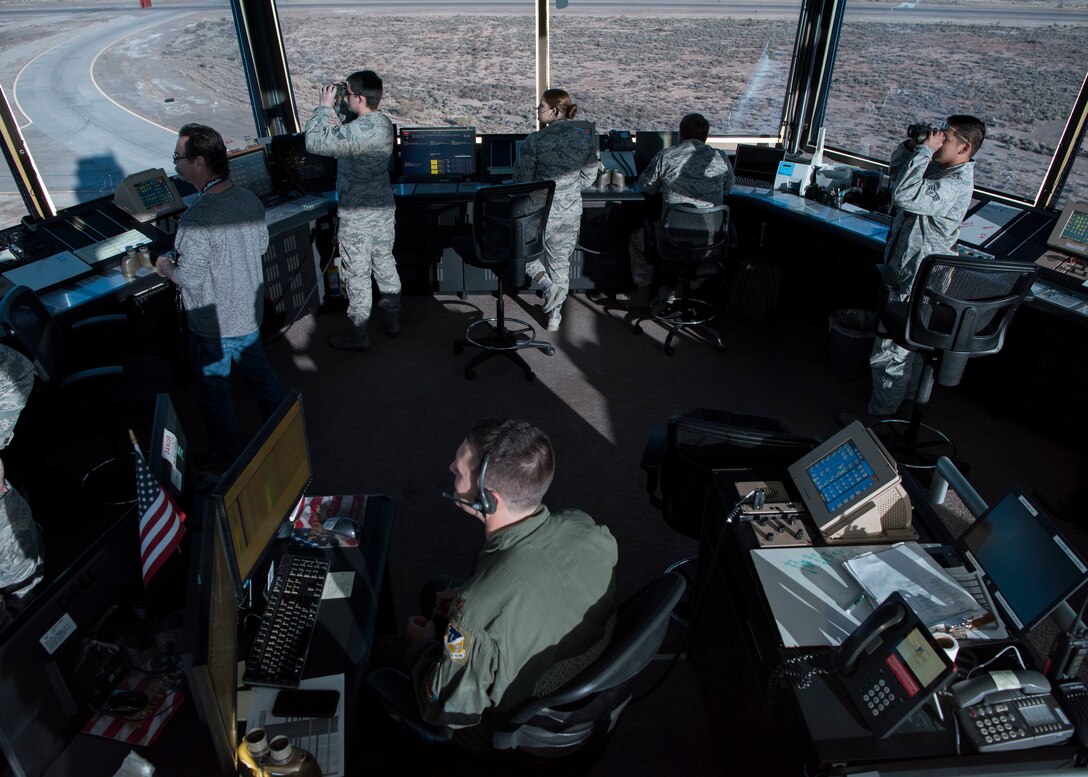 54th Operations Support Squadron air traffic controllers observe F-16 Fighting Falcons taking off, Dec. 20, on Holloman Air Force Base, N.M. The air traffic control tower is divided into five positions with unique responsibilities including ground transportation, flight data, local control, the watch supervisor desk and the supervisor of flight desk (U.S. Air Force photo by Staff Sgt. BreeAnn Sachs)