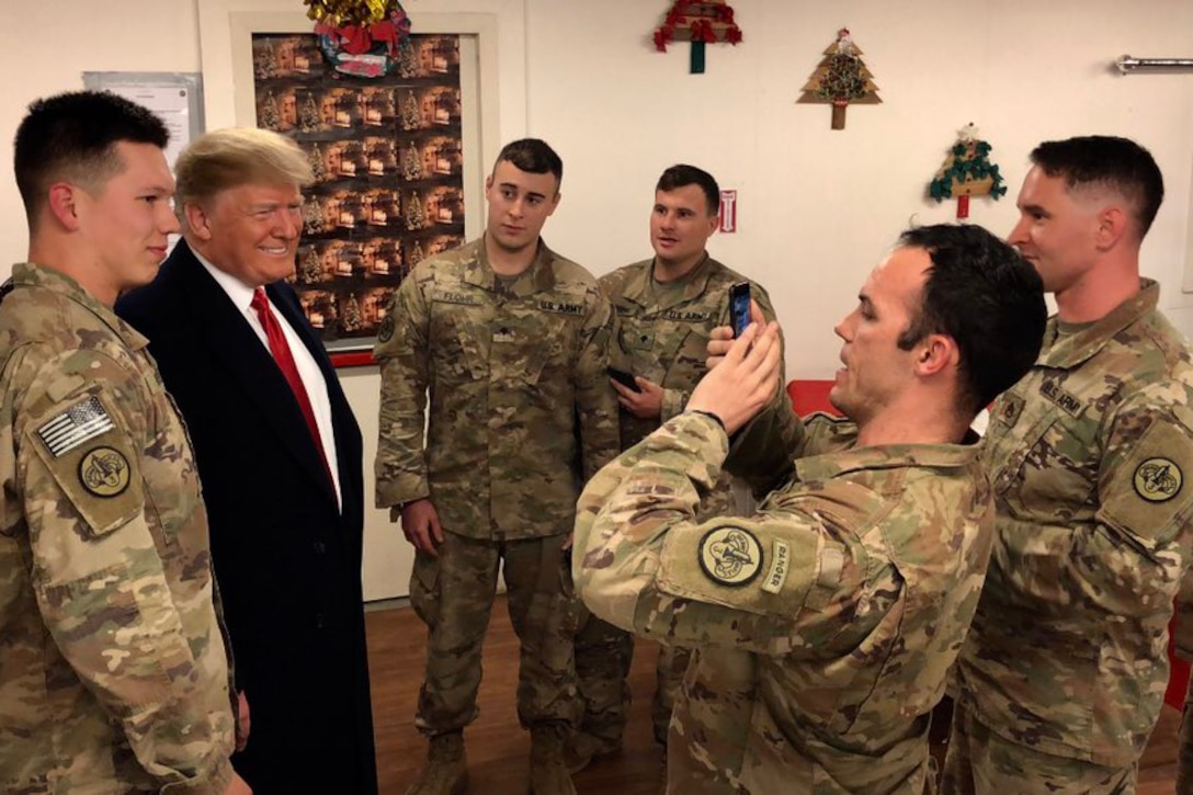 President Donald J. Trump poses for a picture with service members .