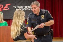 Cpl. Chris Stephens congratulates a student on completing the of the Drug Abuse Resistance Education program
at Laurel Bay, Dec. 17. The goal of the program is the educate students on the danger of substance abuse. Cpl.
Stephens is the school resource officer. (Photo by: Cpl. Debra Sainer/Released