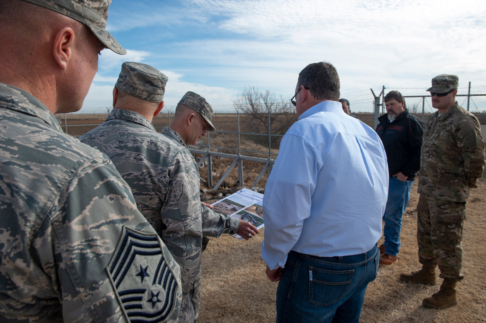 97th Civil Engineer Squadron operations flight shows the innovative improvements made to the gate to U.S. Air Force Lt. Gen. Steven Kwast, commander of Air Education and Training Command and 97th Air Mobility Wing leadership, Dec. 18, 2018, at Altus Air Force Base, Okla.  Several innovative accomplishments implemented by the 97th AMW were highlighted during the tour for Kwast. (U.S. Air Force photo by Senior Airman Cody Dowell)