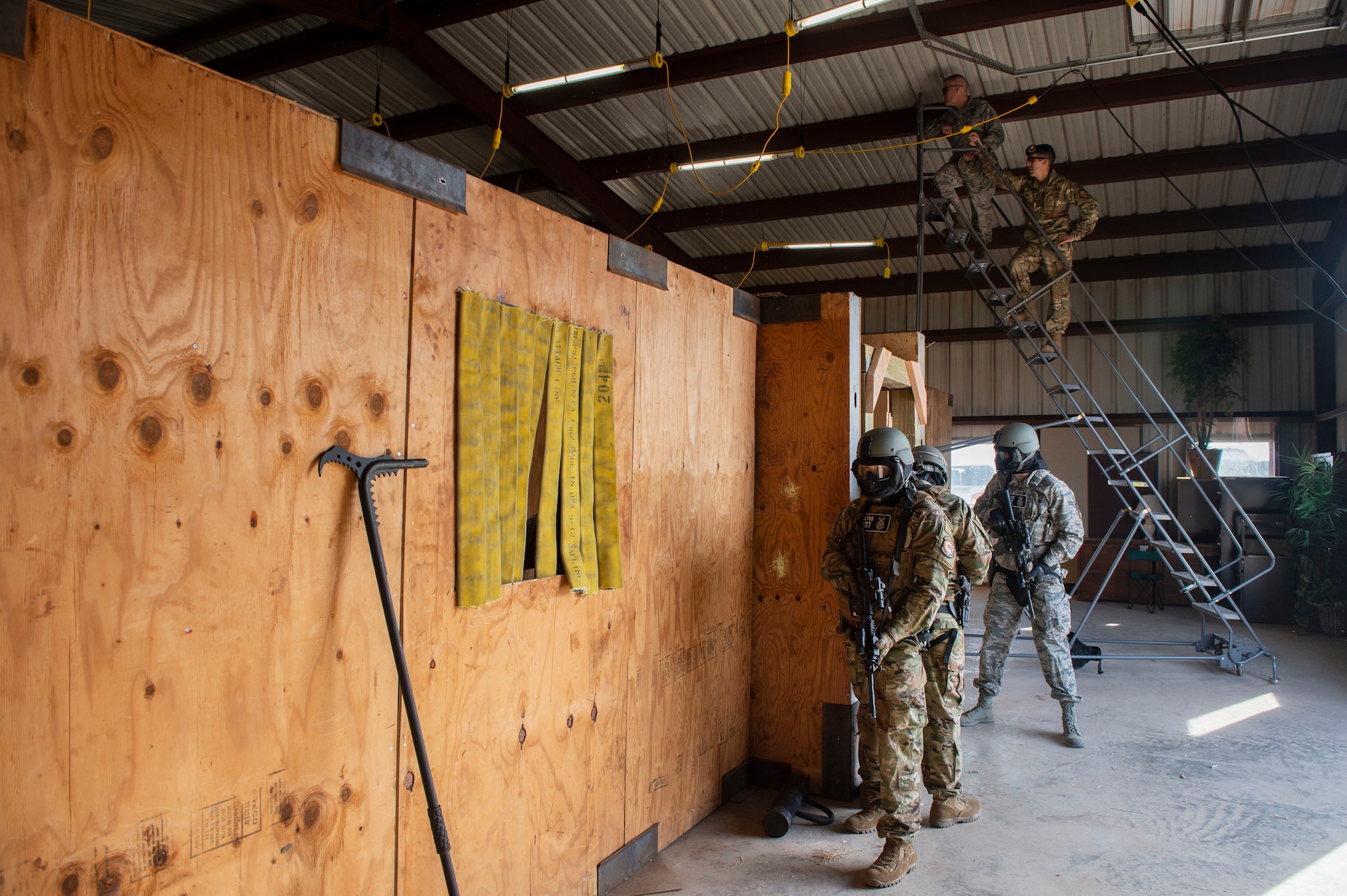 U.S. Air Force Maj. Nathaniel Lesher, 97th Security Forces Squadron commander, shows the aerial view of the shoot house for the new Warrior Training Center to Lt. Gen. Steven Kwast, commander of Air Education and Training Command, Dec. 18, 2018, at Altus Air Force Base, Okla. The mobile stairway allows a wider view of the training in the shoot house. (U.S. Air Force photo by Senior Airman Cody Dowell)