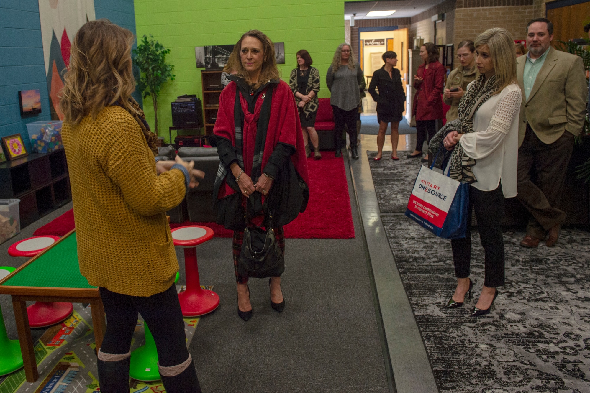 Joni Kwast, wife of U.S. Air Force Lt. Gen. Steven Kwast, commander of Air Education and Training Command, stands beside Tammy Carney, wife of Col. Eric Carney, 97th Air Mobility Wing commander, while they are briefed about the services that the Youth Center provides, Dec. 18, 2018, at Altus Air Force Base, Okla. Kwast toured the family-oriented side of the base, including facilities like: the Youth Center, Child Development Center, Airman and Family Readiness and Outdoor Recreation. The purpose of the tour was to provide Kwast and her husband an understanding of the base and identify how AETC can support future operations. (U.S. Air Force Photo by Senior Airman Jackson N. Haddon)