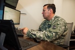 U.S. Army Warrant Officer Escobar, of the Colorado Army National Guard's Cyber Operation Element, supports the Sports - Information Sharing Analysis Organization, Aug. 6, 2016, in Denver, in an effort to protect athletes, spectators, and other entities during the 2016 Olympic Games in Rio de Janeiro, Brazil. (U.S. Air National Guard photo by Maj. Darin Overstreet)