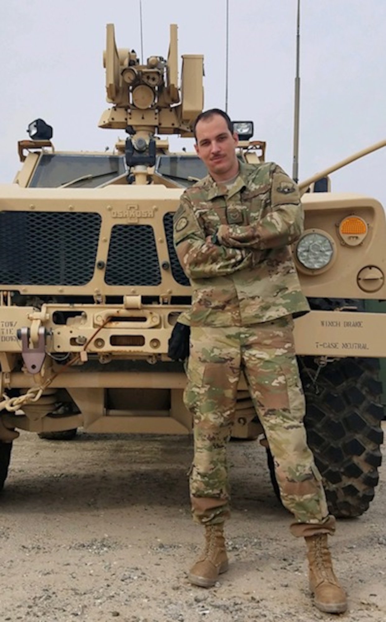 U.S. Air Force Reserve Staff Sgt. Kevin Mailhiot poses in front of a Mine-Resistant Ambush Protected vehicle while deployed to an undisclosed location in Southeast Asia. He is one of four siblings assigned to Little Rock Air Force Base. (Courtesy photo)